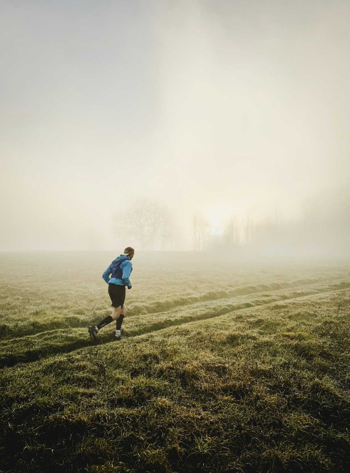 A man running on a mountain trail in the morning